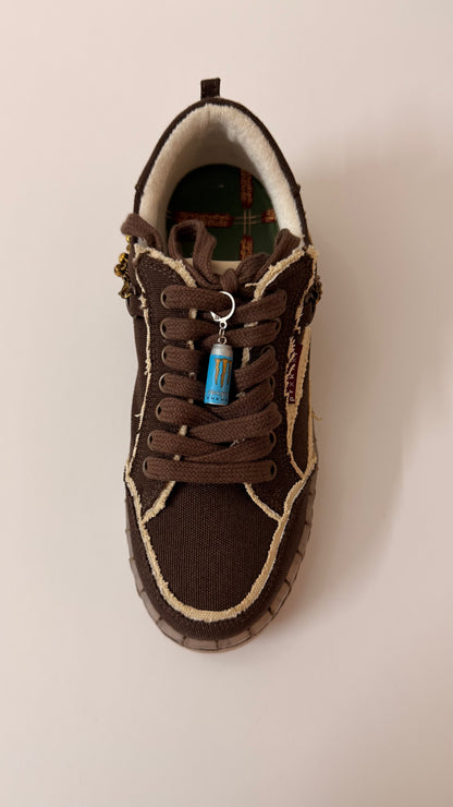 Blue Monster Energy Shoe Charm, mini light blue Monster Energy can charm on the laces of a brown canvas sneaker