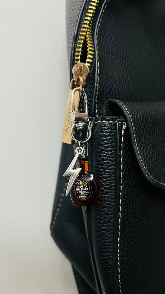 Old Monk rum bottle bag charm with a silver thunderbolt charm (view 2)