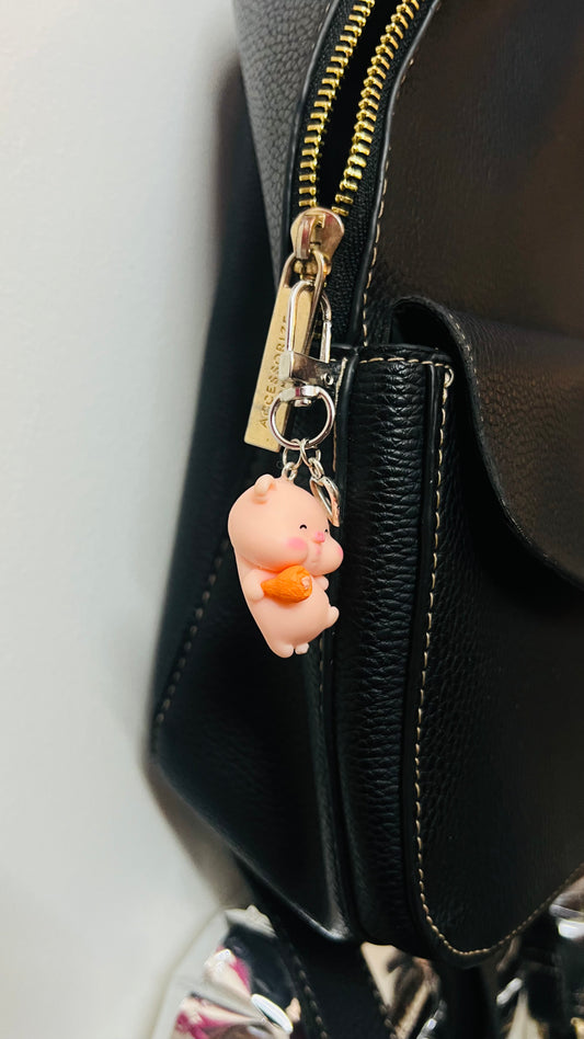 Pink Piggu piglet bag charm hugging a piece of fried chicken (view 2)