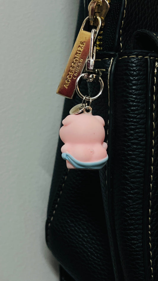 Pink Piggu piglet bag charm wrapped in a blue towel (view 3)