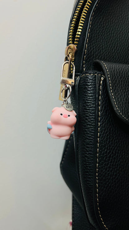 Pink Piggu piglet bag charm wrapped in a blue towel (view 4)