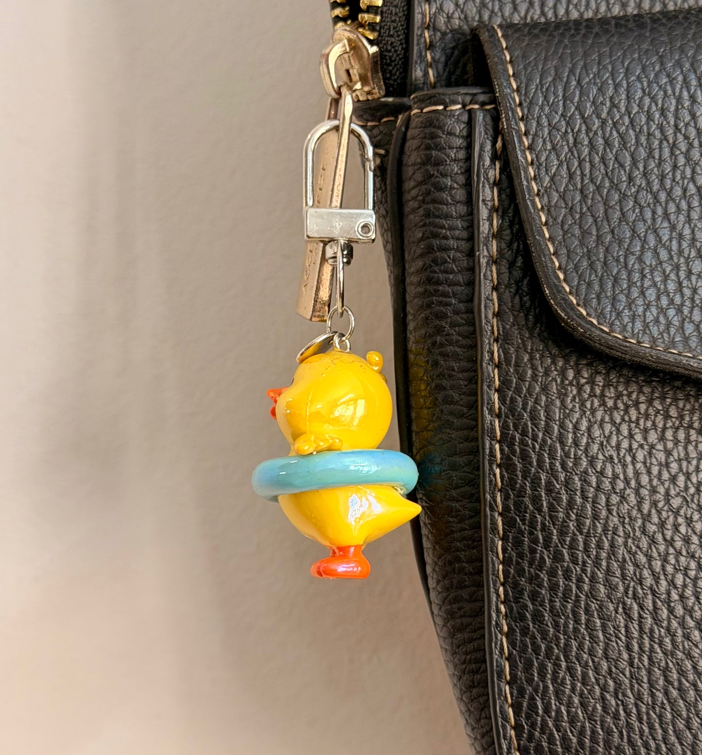 Pool Party Duck, a yellow duck in a pale blue swim ring shown from another angle.