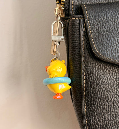 Pool Party Duck, a yellow duck in a pale blue swim ring shown from another angle.
