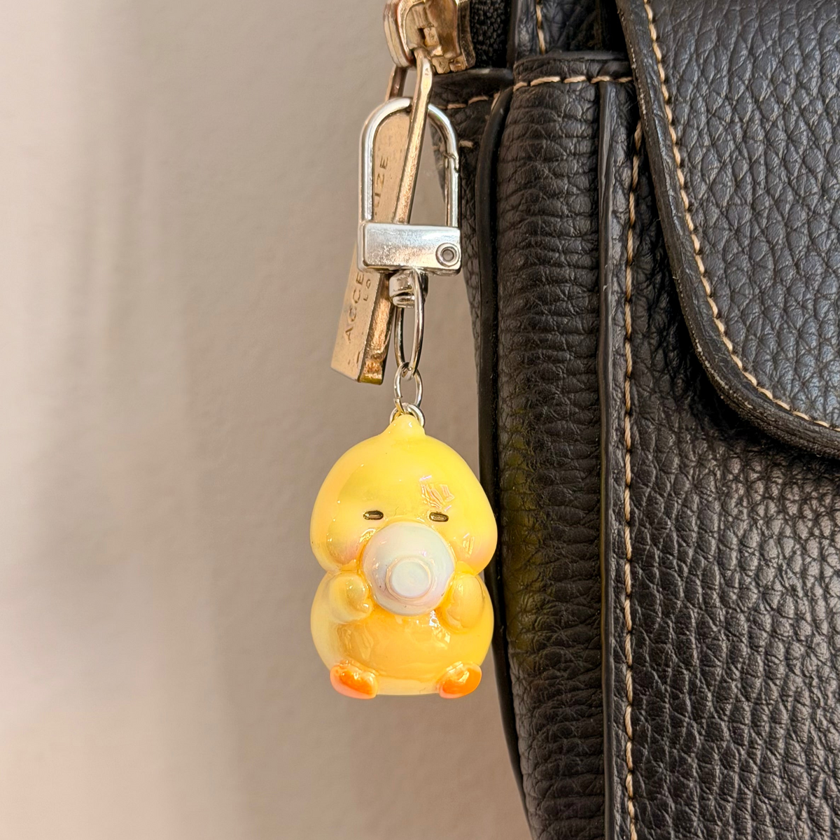 Quack & Snack, a yellow duck holding a white saucer.