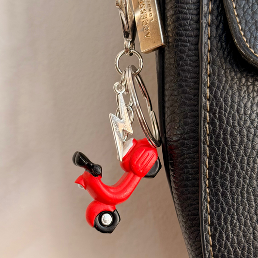 Red Vespa bag charm, a red scooter with a silver thunderbolt charm.