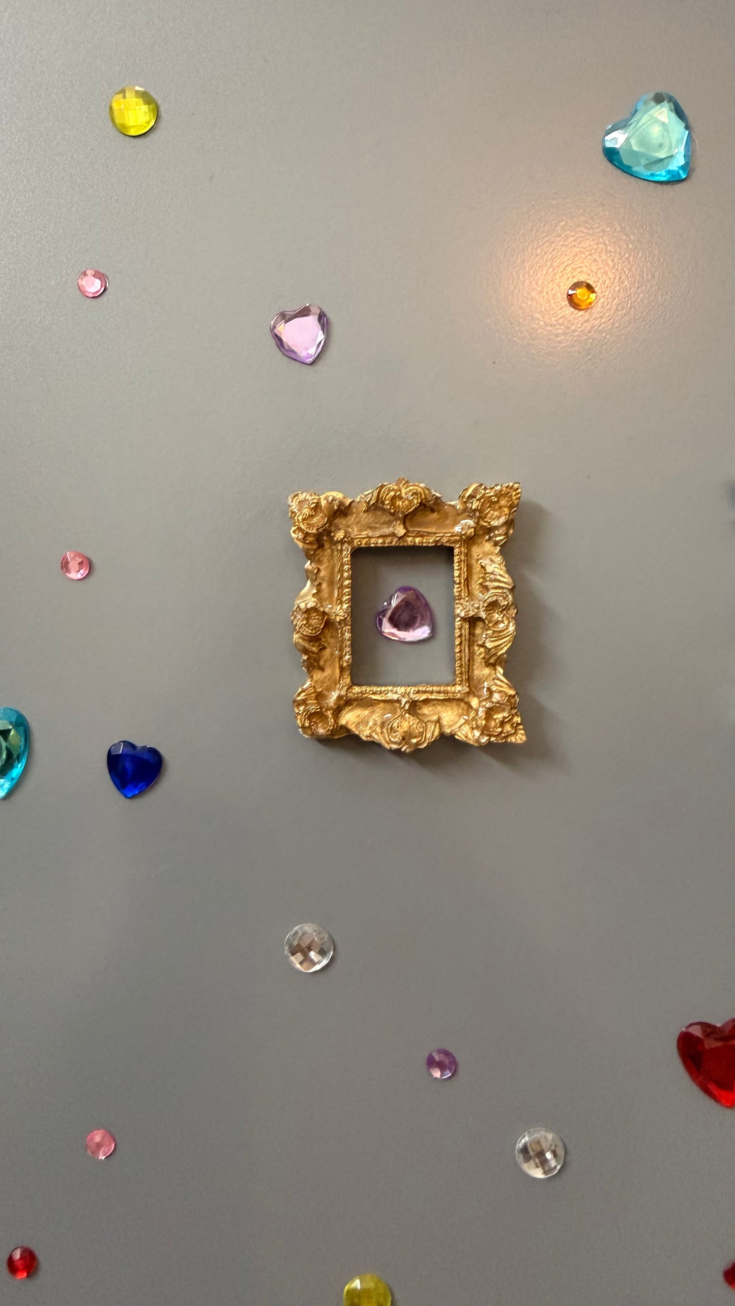 The Relic Magnetic Frame, gold concrete miniature frame with rococo scrollwork around a small rectangular opening