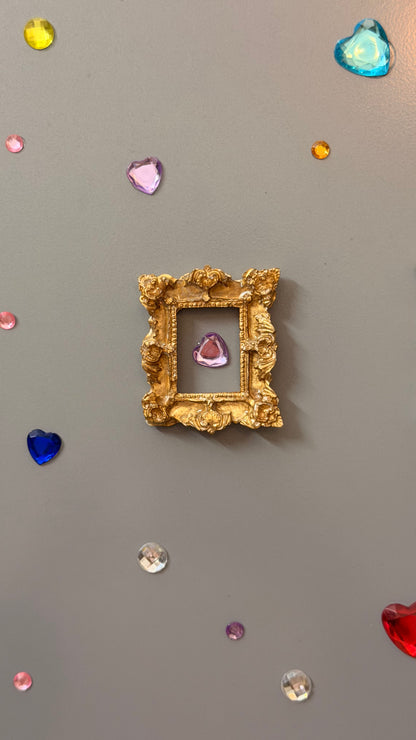 The Relic Magnetic Frame, close view of the gold concrete miniature rococo frame