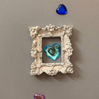 The Relic Magnetic Frame, silver concrete miniature rococo frame on a fridge door