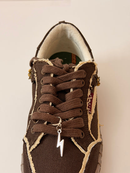 Thunderbolt Shoe Charm, silver lightning bolt charm on the laces of a brown canvas sneaker