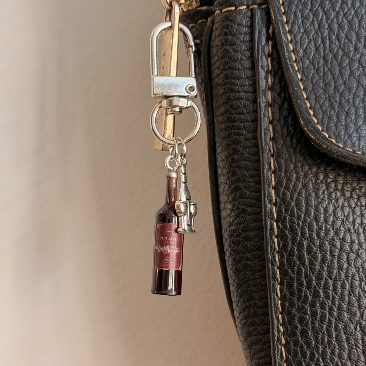 Wine O'Clock, a miniature red wine bottle with a silver corkscrew.