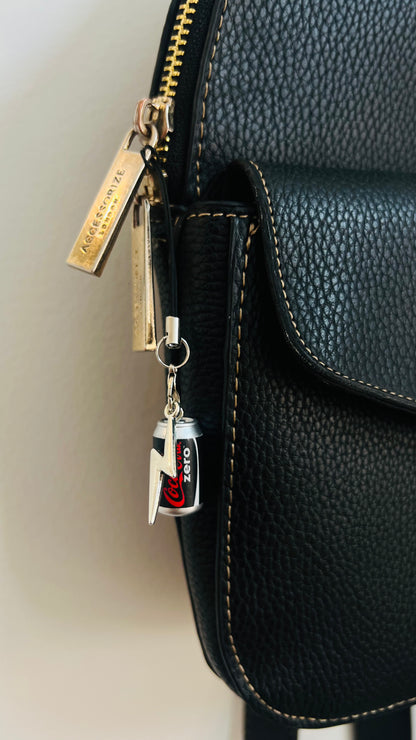 Black Coca-Cola Zero can charm with a silver thunderbolt on a phone strap