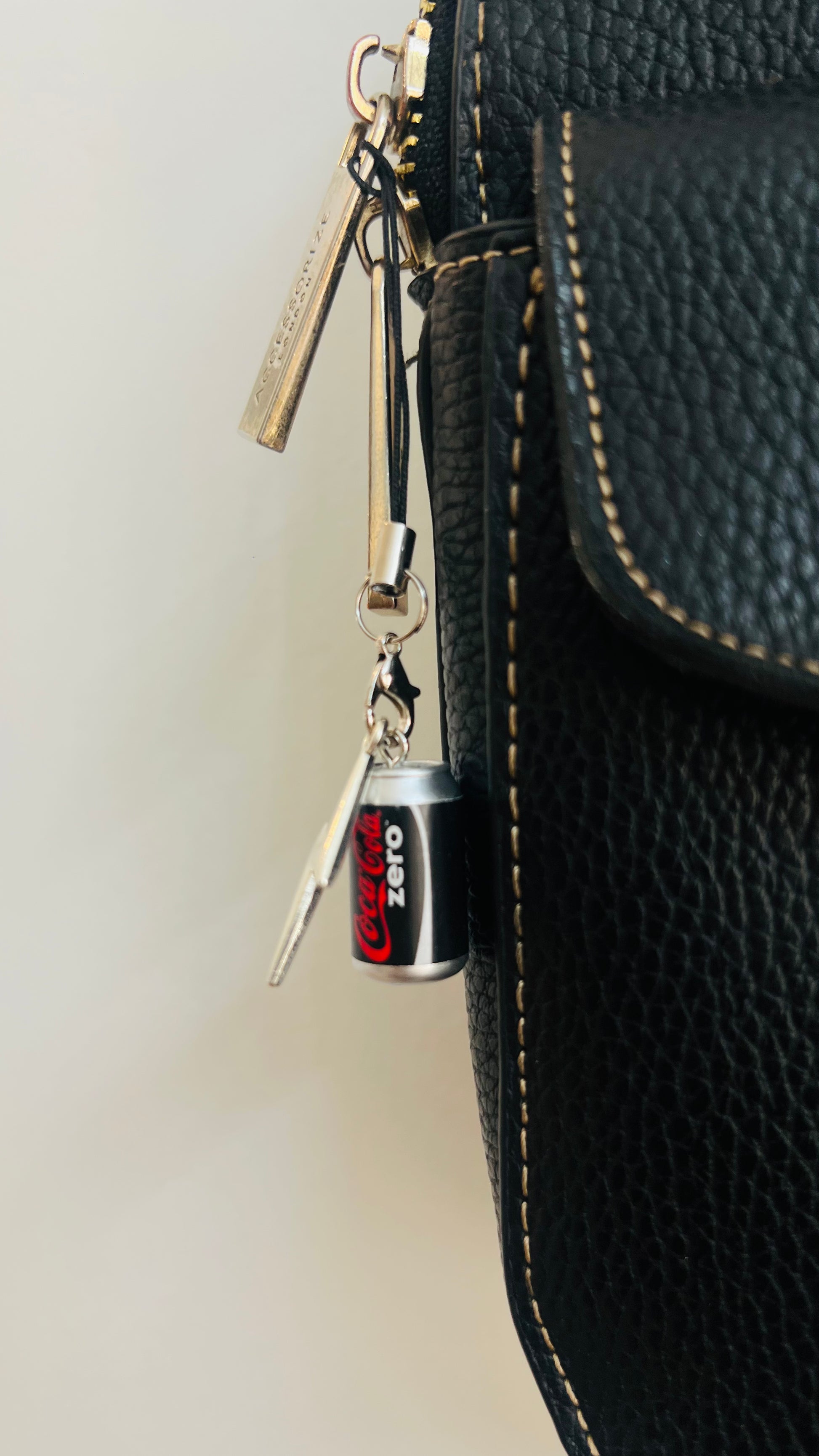 Black Coca-Cola Zero can charm with a silver thunderbolt and star on a phone strap