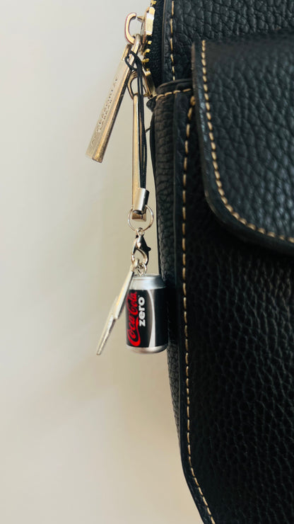 Black Coca-Cola Zero can charm with a silver thunderbolt and star on a phone strap