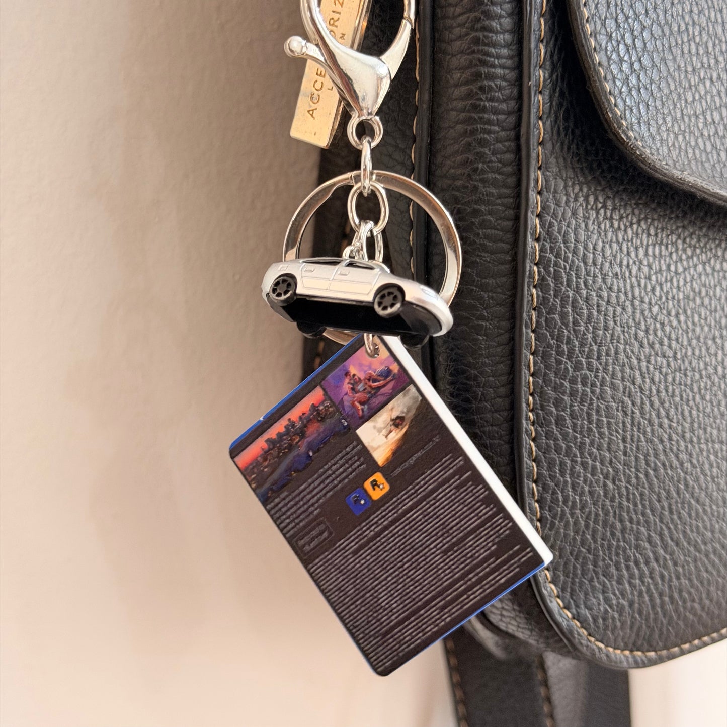 Here We Go Again, back of the mini GTA 6 game case charm with the silver car and keyring