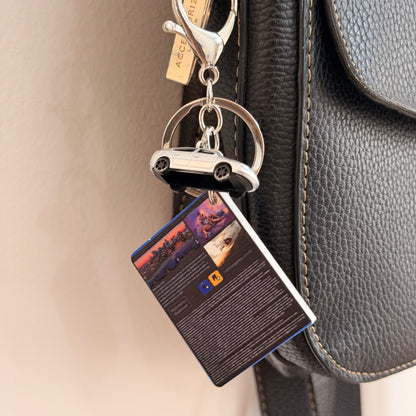 Here We Go Again, back of the mini GTA 6 game case charm with the silver car and keyring