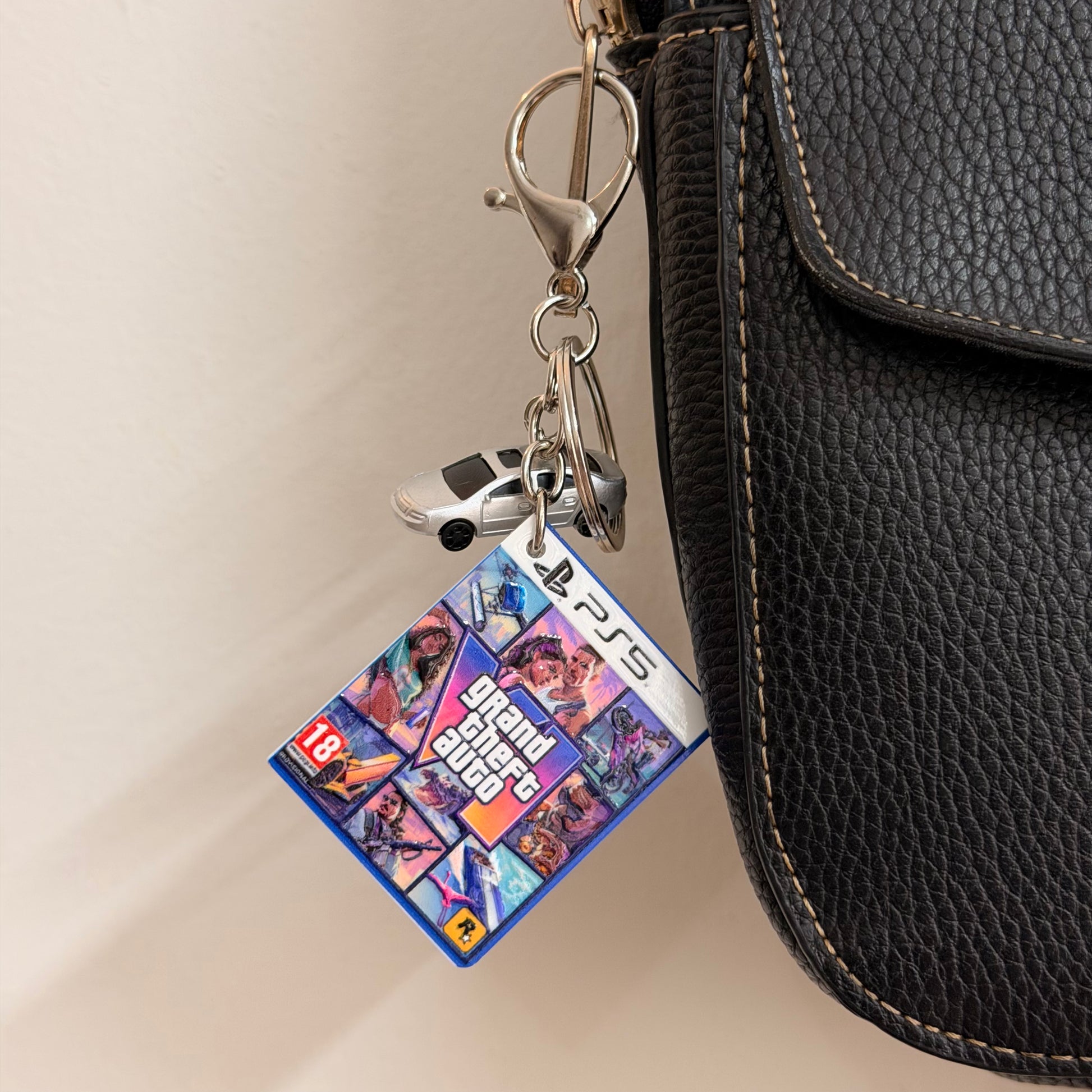 Here We Go Again, close-up of the mini Grand Theft Auto VI PS5 game case charm and silver car