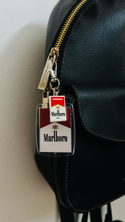 Marlboro acrylic pack keychain clipped to a black bag
