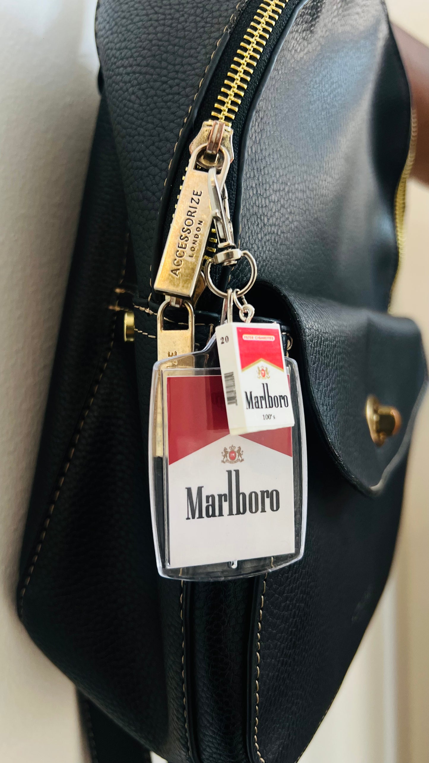 Marlboro acrylic pack keychain with a mini pack charm on a bag